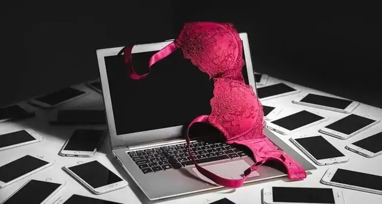 Bra ontop of a laptop in online sex chat scene