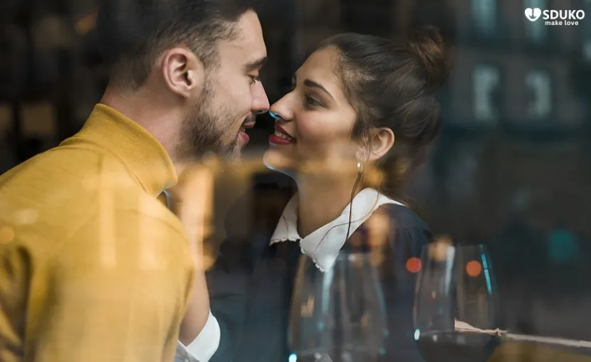 A man and woman about to kiss after a date